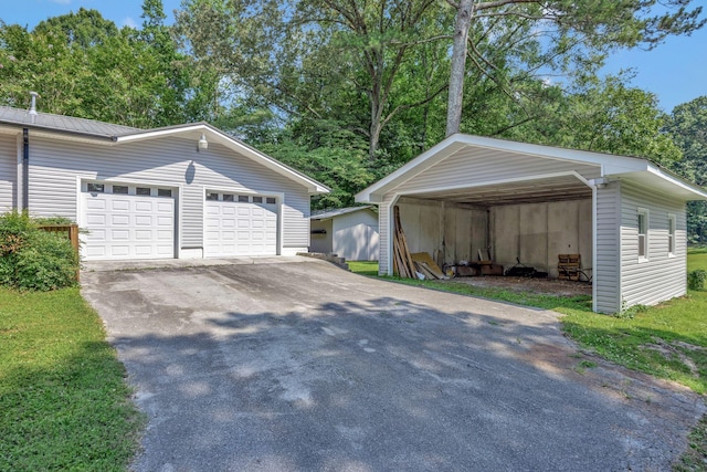 15 Moon Beam Cir, Rock Spring, GA 30739 - garage featuring asphalt driveway and a carport
