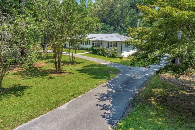 15 Moon Beam Cir, Rock Spring, GA 30739 - view of front of house featuring a front lawn, driveway, and a metal roof