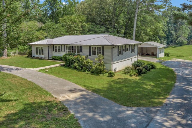15 Moon Beam Cir, Rock Spring, GA 30739 - ranch-style home with driveway, a detached carport, a front yard, a metal roof, and an outbuilding