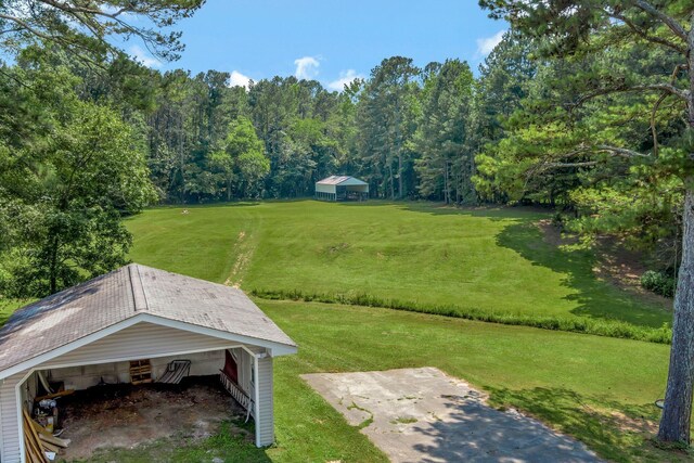 15 Moon Beam Cir, Rock Spring, GA 30739 - view of green lawn with an outdoor structure and a wooded view