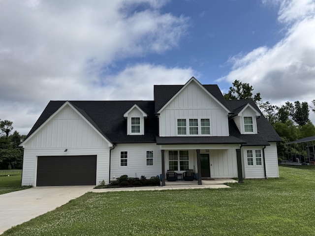 8114 Holly Hills Dr, Chattanooga, TN 37421 - modern farmhouse with board and batten siding, concrete driveway, a front yard, and covered porch