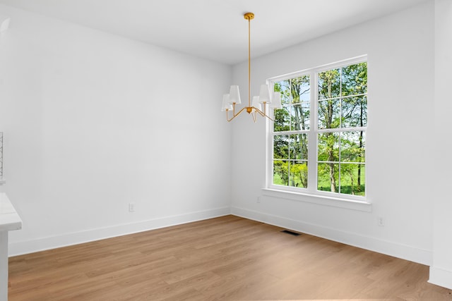 6821 Lakeshore Dr, Chattanooga, TN 37416 - unfurnished dining area featuring a chandelier and light wood-type flooring