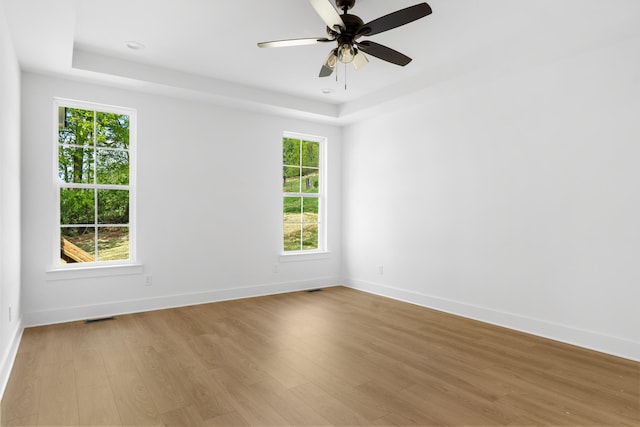 6821 Lakeshore Dr, Chattanooga, TN 37416 - empty room featuring a tray ceiling, light wood-style flooring, and a ceiling fan