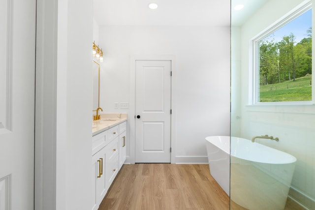 6821 Lakeshore Dr, Chattanooga, TN 37416 - bathroom with a soaking tub, vanity, wood finished floors, and recessed lighting