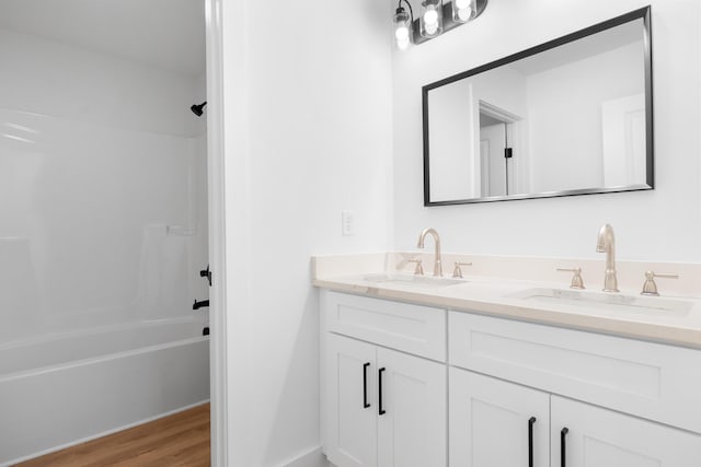 6821 Lakeshore Dr, Chattanooga, TN 37416 - bathroom featuring double vanity, shower / washtub combination, and wood finished floors