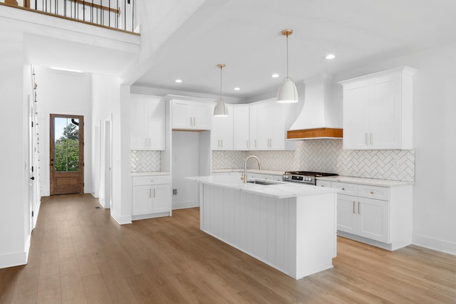 6821 Lakeshore Dr, Chattanooga, TN 37416 - kitchen with premium range hood, stainless steel range with gas stovetop, light wood-style flooring, white cabinetry, and recessed lighting