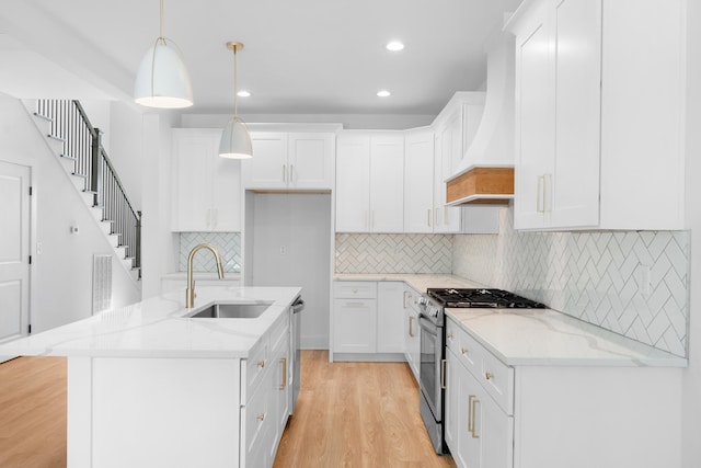 6821 Lakeshore Dr, Chattanooga, TN 37416 - kitchen with stainless steel appliances, light wood finished floors, light stone countertops, white cabinetry, and recessed lighting