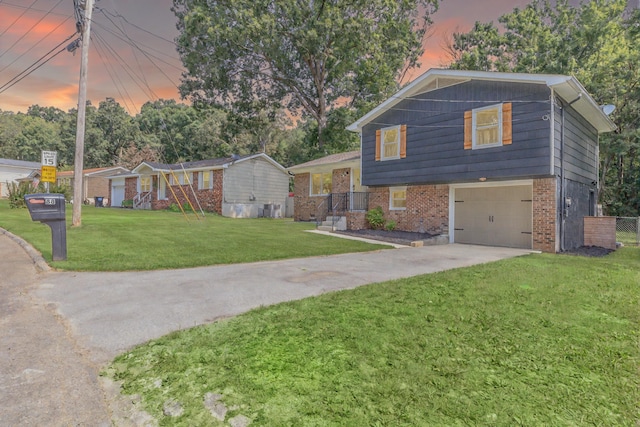 88 Sparrow Ln, Ringgold, GA 30736 - tri-level home featuring concrete driveway, a front yard, brick siding, and an attached garage