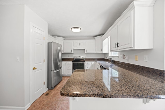75 Sequoyah Trl, Ringgold, GA 30736 - kitchen featuring stainless steel appliances, a peninsula, under cabinet range hood, white cabinets, and dark stone counters
