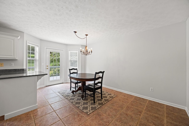75 Sequoyah Trl, Ringgold, GA 30736 - dining area featuring a chandelier, light tile patterned floors, and a textured ceiling