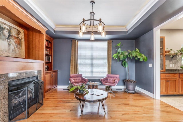 7918 Chianti Way, Chattanooga, TN 37421 - sitting room with ornamental molding, a chandelier, a high end fireplace, light wood-style floors, and a raised ceiling