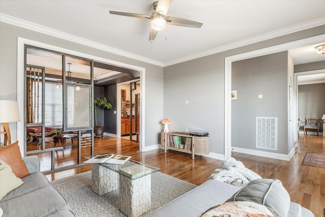 7918 Chianti Way, Chattanooga, TN 37421 - living room with wood finished floors, ornamental molding, ceiling fan, and a chandelier