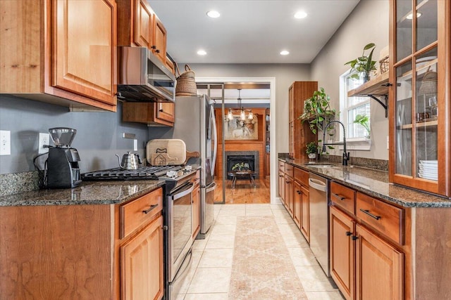 7918 Chianti Way, Chattanooga, TN 37421 - kitchen with appliances with stainless steel finishes, dark stone counters, recessed lighting, and brown cabinets