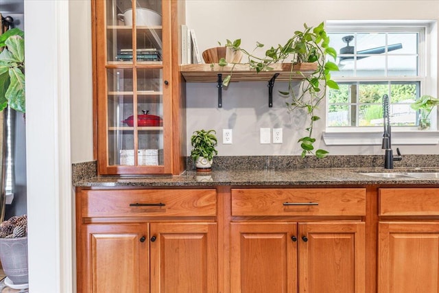 7918 Chianti Way, Chattanooga, TN 37421 - kitchen with dark stone counters, glass insert cabinets, and brown cabinetry