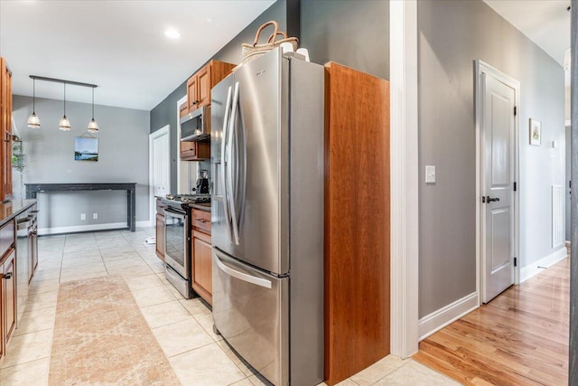 7918 Chianti Way, Chattanooga, TN 37421 - kitchen with stainless steel appliances, brown cabinets, dark countertops, and pendant lighting