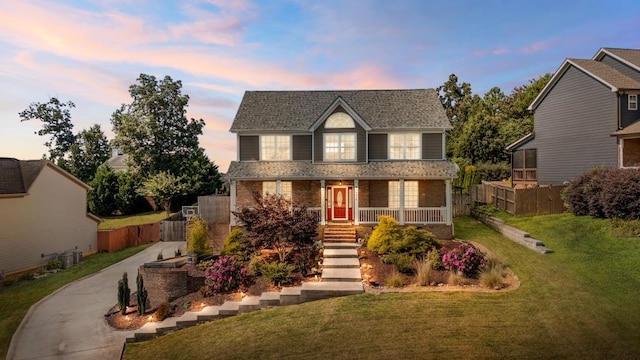 7918 Chianti Way, Chattanooga, TN 37421 - traditional-style home with covered porch, concrete driveway, brick siding, roof with shingles, and stairs