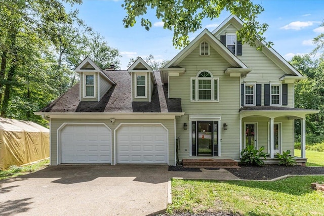 2416 Mourning Dove Ln, Signal Mountain, TN 37377 - view of front facade with driveway, a garage, a porch, a front yard, and roof with shingles