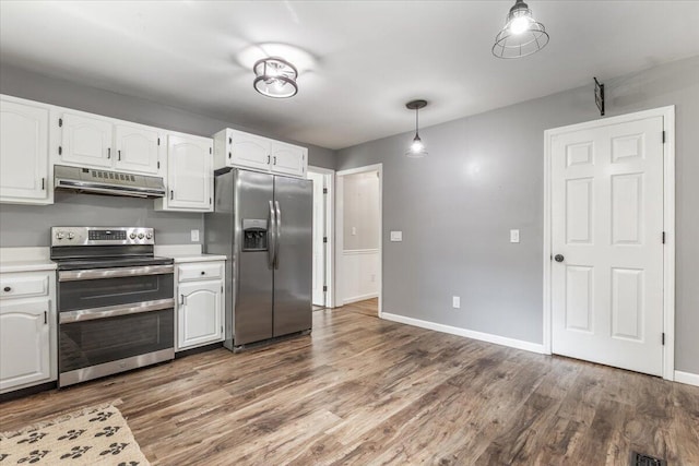 2416 Mourning Dove Ln, Signal Mountain, TN 37377 - kitchen with stainless steel appliances, under cabinet range hood, light countertops, wood finished floors, and white cabinets