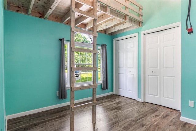 2416 Mourning Dove Ln, Signal Mountain, TN 37377 - unfurnished bedroom with beamed ceiling, wood finished floors, and multiple closets