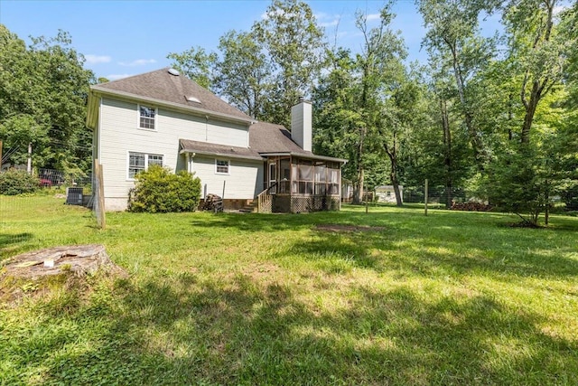 2416 Mourning Dove Ln, Signal Mountain, TN 37377 - rear view of property with a sunroom, a chimney, and a lawn