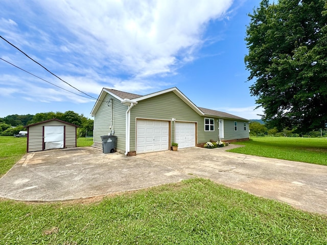 1828 Saunders Rd, Ringgold, GA 30736 - view of property exterior featuring a lawn, concrete driveway, a garage, and a storage unit