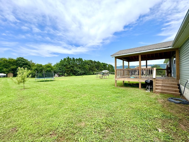 1828 Saunders Rd, Ringgold, GA 30736 - view of green lawn with a trampoline and a deck