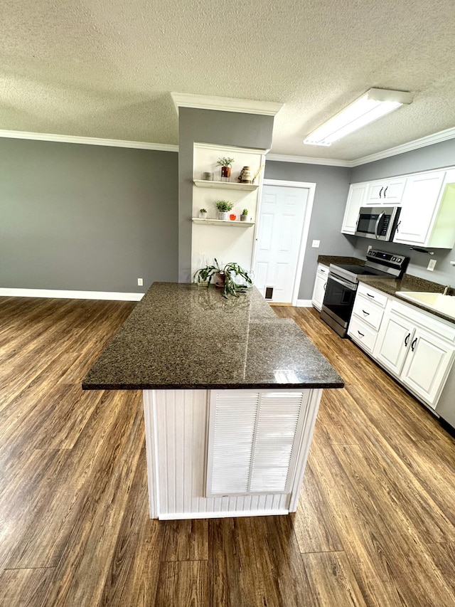 1828 Saunders Rd, Ringgold, GA 30736 - kitchen with appliances with stainless steel finishes, ornamental molding, dark wood-style floors, open shelves, and a textured ceiling
