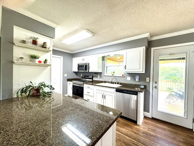 1828 Saunders Rd, Ringgold, GA 30736 - kitchen featuring stainless steel appliances, white cabinetry, crown molding, dark wood-type flooring, and a textured ceiling