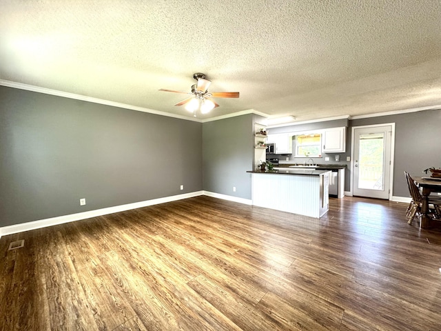 1828 Saunders Rd, Ringgold, GA 30736 - unfurnished living room featuring crown molding, a ceiling fan, a textured ceiling, and dark wood-style flooring