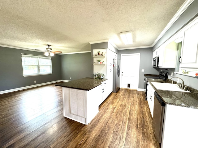 1828 Saunders Rd, Ringgold, GA 30736 - kitchen featuring stainless steel appliances, dark wood-style flooring, a peninsula, a textured ceiling, and white cabinetry