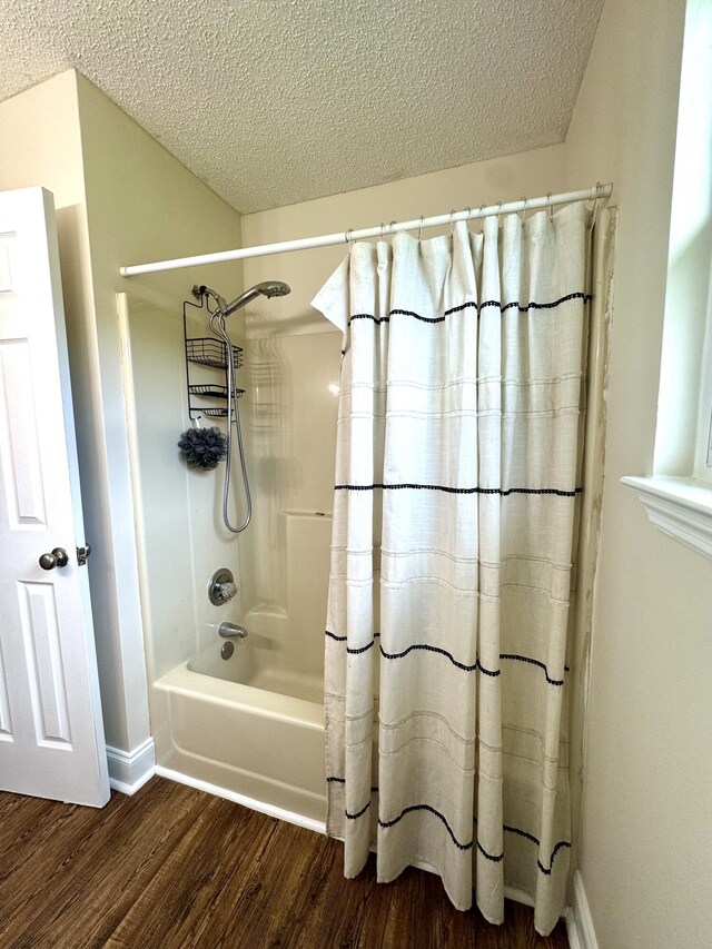1828 Saunders Rd, Ringgold, GA 30736 - bathroom with wood finished floors, shower / bath combination with curtain, and a textured ceiling