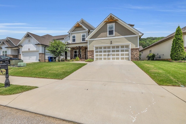 5644 Bungalow Cir, Hixson, TN 37343 - craftsman-style home with stone siding, a garage, a front yard, driveway, and board and batten siding