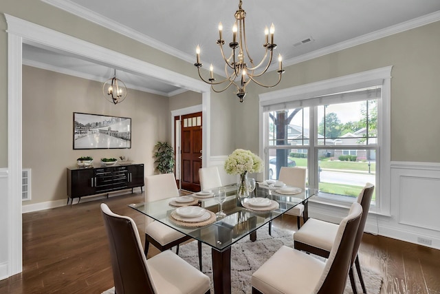 5644 Bungalow Cir, Hixson, TN 37343 - dining area with a chandelier, wood finished floors, crown molding, a wainscoted wall, and a decorative wall