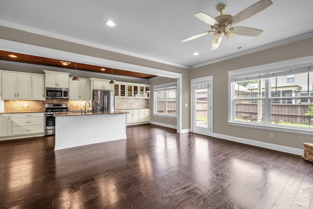 5644 Bungalow Cir, Hixson, TN 37343 - kitchen with appliances with stainless steel finishes, decorative backsplash, healthy amount of natural light, crown molding, and an island with sink