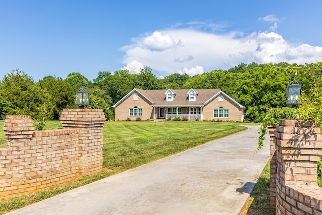305 River Pointe Cir NE, Charleston, TN 37310 - cape cod house with a front lawn and brick siding