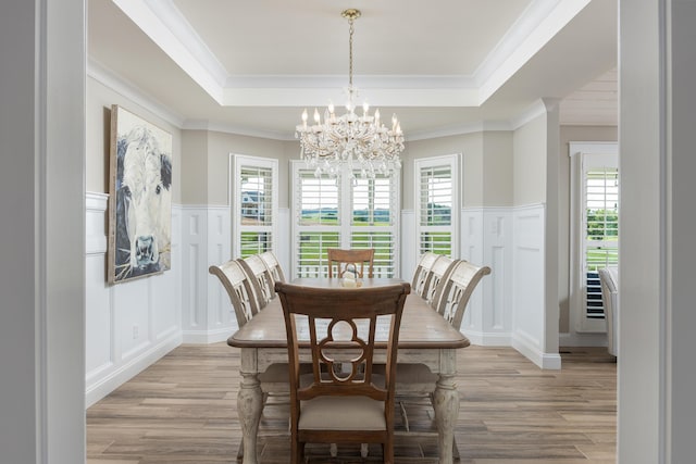 305 River Pointe Cir NE, Charleston, TN 37310 - dining area featuring a decorative wall, light wood-style floors, a chandelier, a tray ceiling, and crown molding