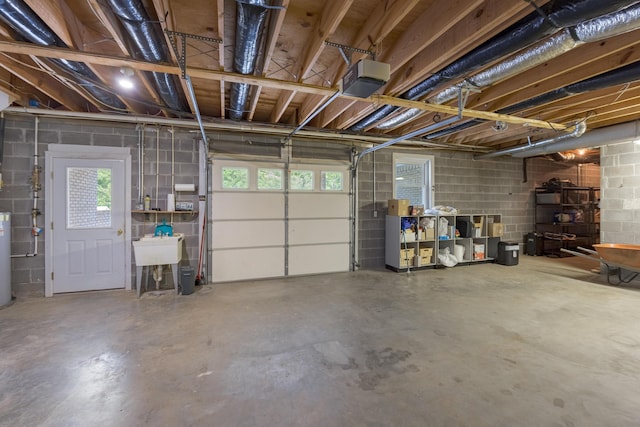 305 River Pointe Cir NE, Charleston, TN 37310 - garage featuring a garage door opener, concrete block wall, and water heater