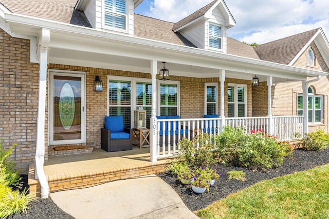 305 River Pointe Cir NE, Charleston, TN 37310 - property entrance featuring covered porch, roof with shingles, and brick siding