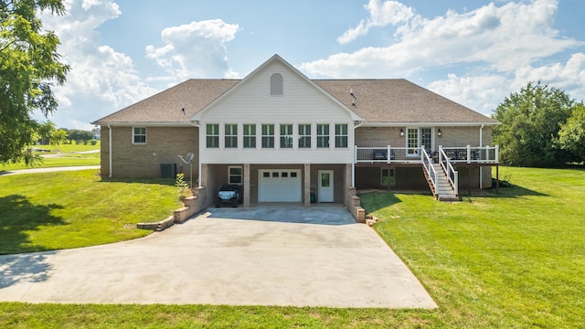305 River Pointe Cir NE, Charleston, TN 37310 - back of property with brick siding, concrete driveway, a garage, a wooden deck, and stairway