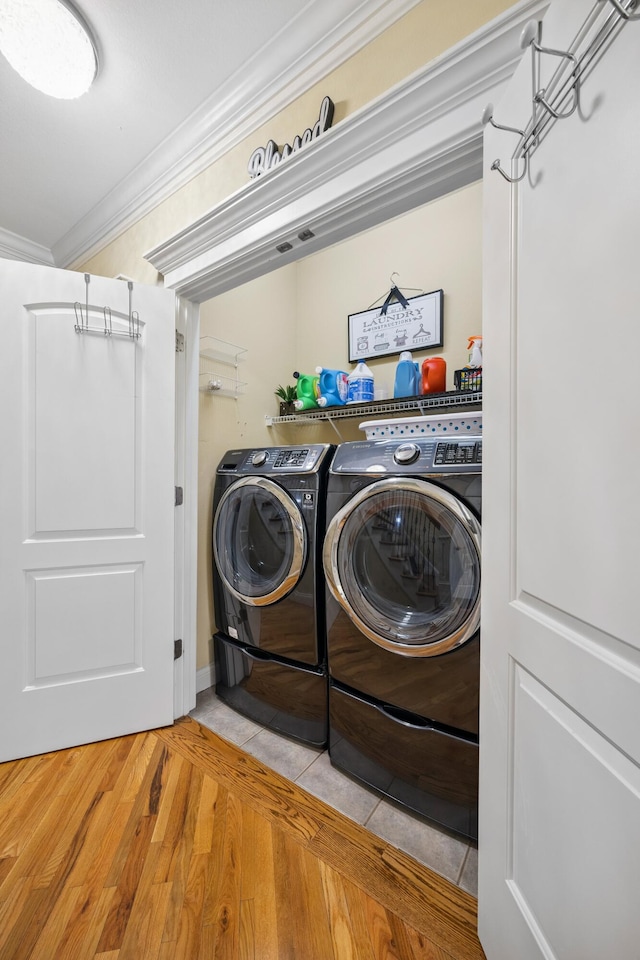 2507 Saint Lucie Ct, Chattanooga, TN 37421 - laundry area featuring ornamental molding, washer and clothes dryer, and wood finished floors