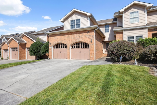 2507 Saint Lucie Ct, Chattanooga, TN 37421 - view of front of home with brick siding, concrete driveway, a front lawn, and an attached garage