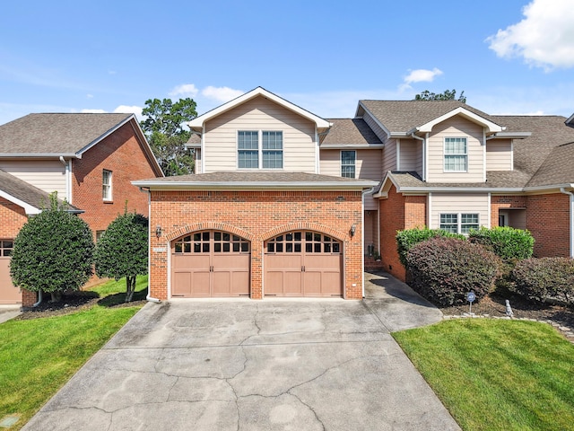 2507 Saint Lucie Ct, Chattanooga, TN 37421 - view of front of house featuring brick siding, driveway, a garage, a shingled roof, and a front yard