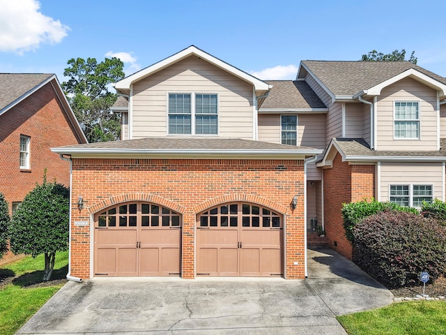 2507 Saint Lucie Ct, Chattanooga, TN 37421 - view of front of home featuring a garage, brick siding, driveway, and a shingled roof