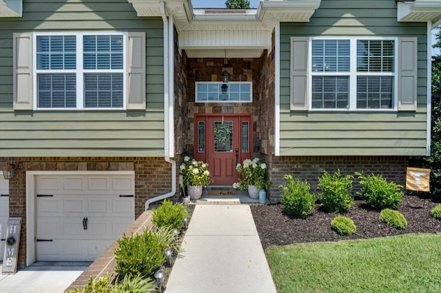 9129 Wood Dale Ln, Hixson, TN 37343 - view of exterior entry with an attached garage and concrete driveway