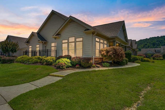 9624 Collier Pl, Ooltewah, TN 37363 - property exterior at dusk featuring a yard and a shingled roof