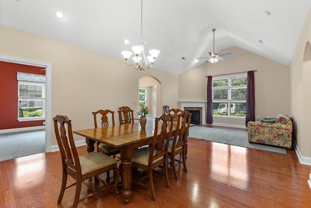 9624 Collier Pl, Ooltewah, TN 37363 - dining space featuring arched walkways, wood finished floors, lofted ceiling, ceiling fan, and a fireplace