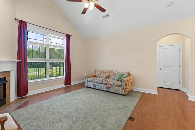 9624 Collier Pl, Ooltewah, TN 37363 - living area featuring ceiling fan, wood finished floors, vaulted ceiling, a fireplace, and arched walkways