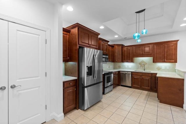 9624 Collier Pl, Ooltewah, TN 37363 - kitchen with appliances with stainless steel finishes, light countertops, tasteful backsplash, a tray ceiling, and light tile patterned flooring