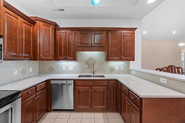 9624 Collier Pl, Ooltewah, TN 37363 - kitchen with appliances with stainless steel finishes, light countertops, a peninsula, tasteful backsplash, and recessed lighting