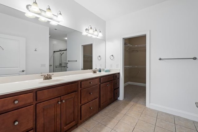 9624 Collier Pl, Ooltewah, TN 37363 - full bathroom featuring tile patterned flooring, double vanity, a walk in closet, and a shower stall